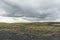 Vast land covered with gravel and moss in Iceland on cloudy day