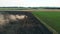 Vast landscape with a tractor sowing a massive field