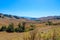 Vast mountain landscape with green trees, blue sky, and clouds at Chino Hills State Park