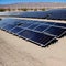 Vast outdoor solar panel farm in a desert.