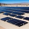 Vast outdoor solar panel farm in a desert.