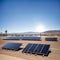 Vast outdoor solar panel farm in a desert.