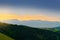 Vast panorama view of foggy valley in the Owl Mountains with silhouette of Sudetes mountain range at dusk. Poland.