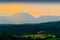 Vast panorama view of valley in the Owl Mountains with silhouette of Sudetes mountain range at dusk. Poland.