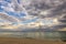 vast seascape from the seashore with cloudy sky