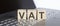 VAT abbreviation stands for written on a wooden cube on laptop