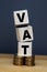 VAT Concept. Word VAT with stacked coins