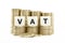 VAT (Value Added Tax) on gold coins on white backg