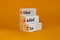 VAT, value added tax symbol. Wooden blocks with concept words `VAT, value added tax`. Beautiful orange background, copy space.
