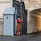 VATICAN CITY, ROME - APRIL 29, 2019: Traditional Papal Swiss guard with halberd in front of a sentry-box, outside of the St. Peter