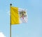 Vatican flag against blue sky