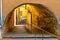 Vault tunnel passage in rock bedding beneath historic medieval tenement houses in old town of perfumery city of Grasse in France