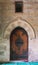 Vaulted closed decorated wooden grunge door in bricks stone wall