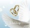 Vctor illustration of white dove wings and two wedding rings, symbol of love