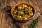 Veal beef oxtails tails stew with vegetables in a wooden plate. wooden background. Top view