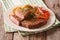 Veal breaded rump steak and garnished with vegetables close-up.