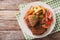 Veal breaded rump steak and garnished with vegetables close-up.