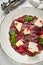 Veal carpaccio with parmesan and pomegranate sauce