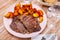 Veal entrecote with grilled potatoes with tomato sauce