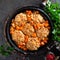 Veal meatballs stewed in frying pan with carrot in vegetable sauce. Delicious meat dish