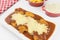 Veal parmigiana in a white platter with rice in and french fries in white background seen from above