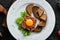 Veal tartar with egg yolk and black bread.