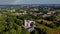 Vecauce Manor in Latvia Aerial View of the Pink Castle Through the Park. Vecauce Castle Tower With a Flying Latvian Flag.