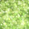 Vector abstract green sparkling background with blurred lights