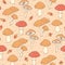 Vector autumn seamless pattern with amanita and cap mushrooms and acorns on the beige dotted background. Vintage ornament