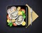 Vector of dish with oysters, mussels and prawns served lemon and basil in square black plate with fork, top view