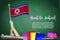 Vector flag of North Korea on Black chalkboard background. Education Background with Hands Holding Up of North Korea flag. Back t