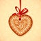 Vector gingerbread heart on red ribbon