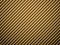 Vector golden carbon fiber volume background. Abstract decoration cloth material wallpaper with shadow for car tuning