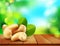 Vector group of cashew nuts lying on a wooden table on the background of the sky and green foliage
