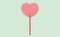 Vector heart shaped sucking candy on a stick. Sweetness on a green background. Flat design