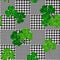 Vector houndstooth seamless black and white pattern with green shamrocks