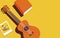 Vector illustration of a guitar and other items on a yellow background. Minimalistic illustration in trendy colors