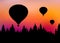 Vector illustration of landscape with forest, flying hot air balloons and orange sky