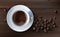 Vector illustration of a realistic style of white coffee cup with a saucer and coffee beans, top view