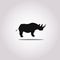 Vector illustration of a silhouette of a rhino standing on isolated white background. Rhinoceros side view profile.