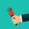 Vector journalism concept. Hand holding microphone icon. News or interview concept symbol or logo in flat style