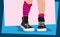 Vector legs of a teenager in sneakers and leggings