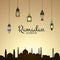 Vector Ramadan illustration with lanterns and arabic city silhouette