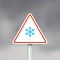 Vector road sign with snowflake on gray sky background