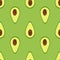 Vector seamless background with half sliced avocado fruit on a green background