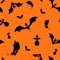 Vector seamless halloween bats silhouette on orange background