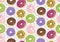 Vector seamless pattern with colorful donuts. Glaze, sprinkle and chocolate donuts with hand drawn texture.