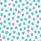 Vector seamless pattern with randomly placed pink and mint hand drawn polka dots on a white background