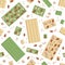 Vector seamless pattern of white and green chocolate bars with cashews, hazelnuts, almonds and pieces isolated on white