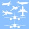 Vector Set of White Silhouette Passenger Planes on Blue Background.
